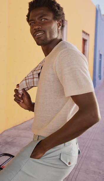 Model posing on colorful street wearing Linen Blend Sweater Tee and Italian Stretch Chinos