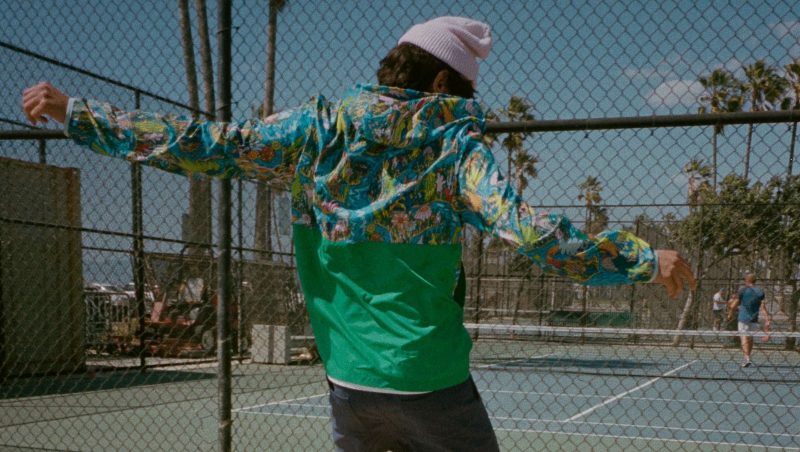 Young man on basketball court in Mike Perry x Fielder jacket