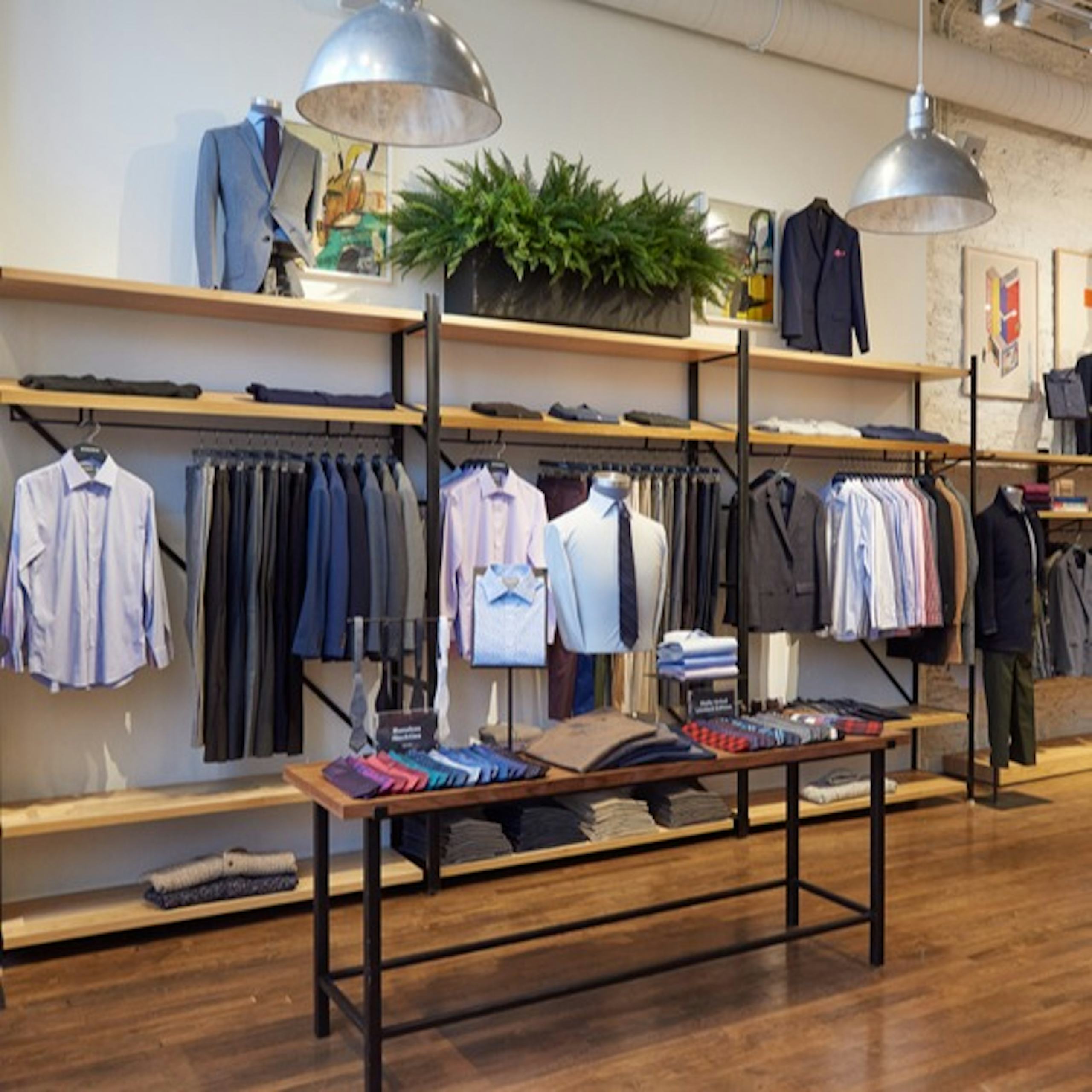 Image of Bonobos in North Loop, Minneapolis. Display is of casual shirts, dress pants, suits and blazers. 