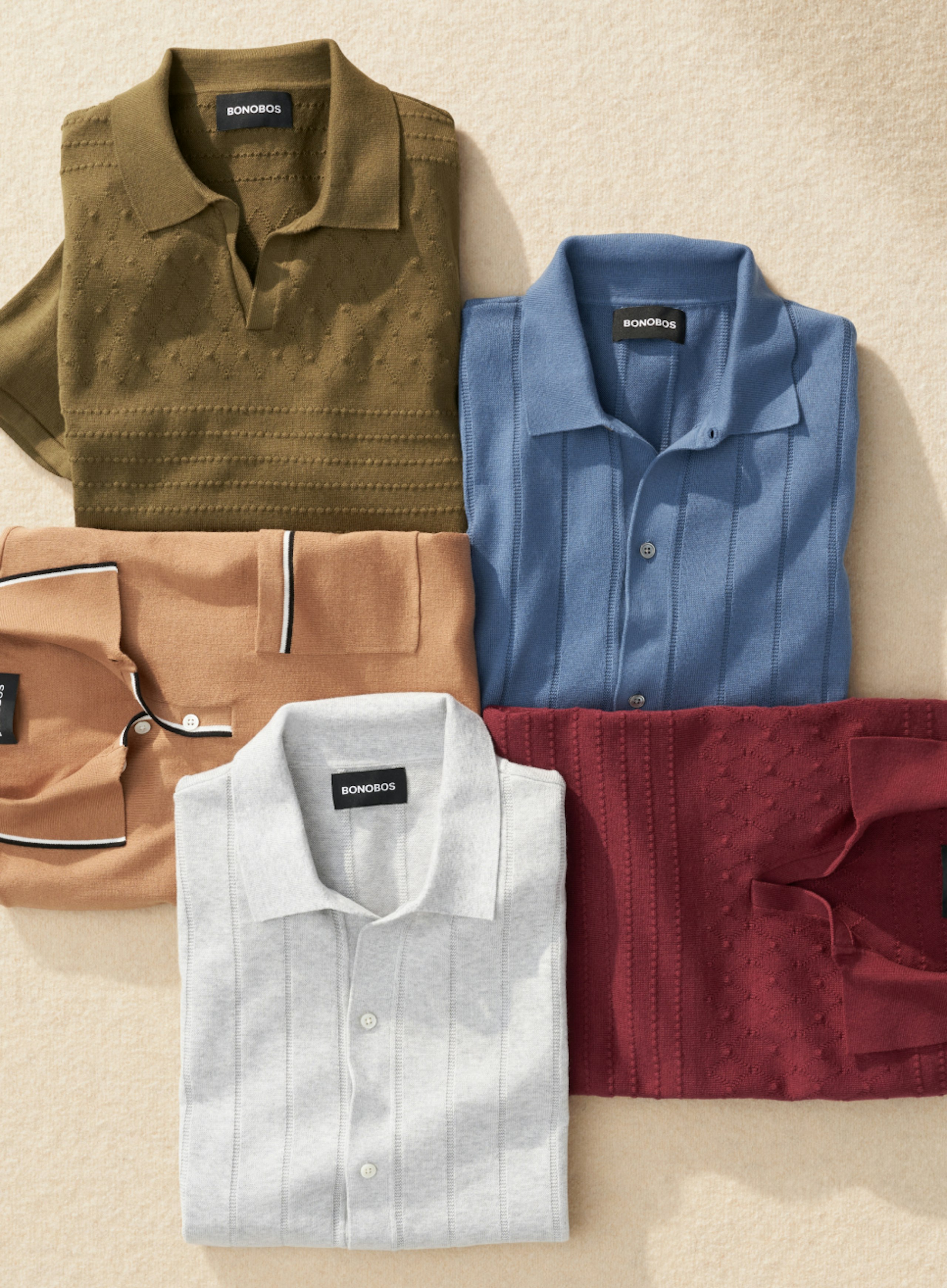 Arrangement of 4 folded polos in fall colors 