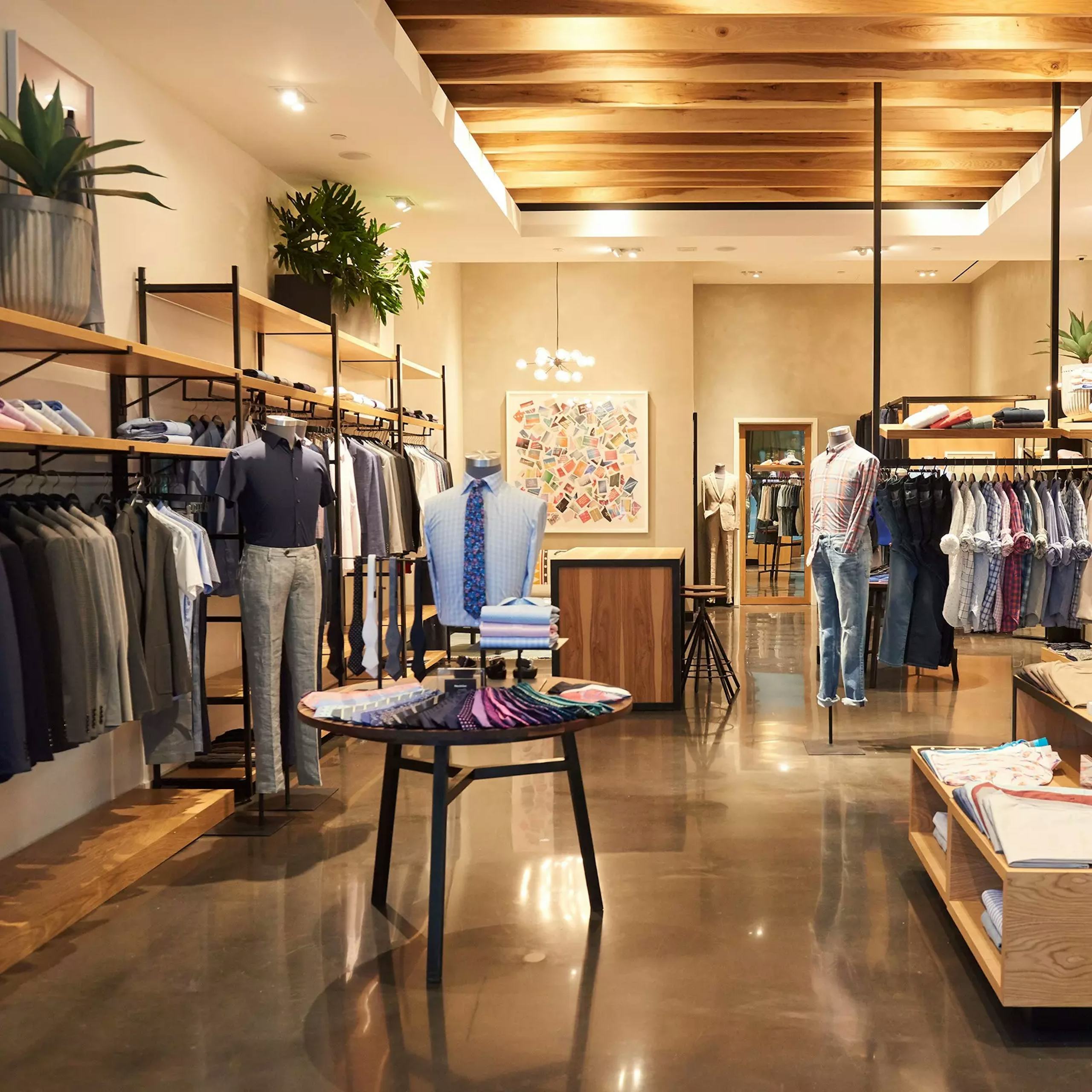 Image of Bonobos store in Century City Mall, Los Angeles. Display has casual shirts, pants, suits and blazers. 