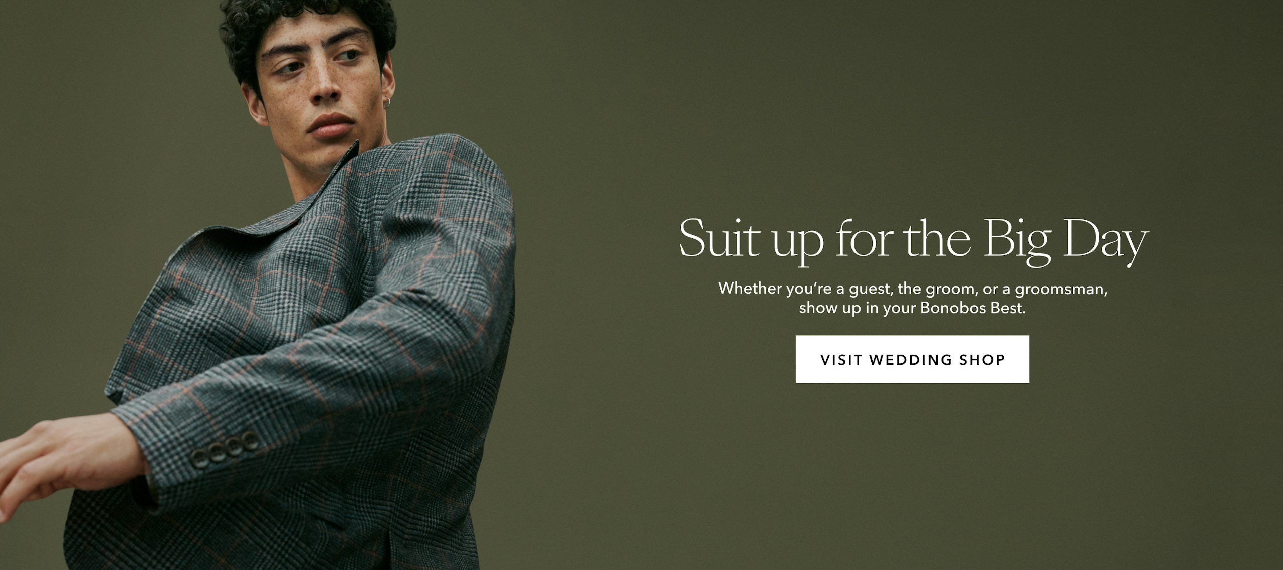 Man in suit, text reads: Suit up for the Big Day Whether you’re a guest, the groom, or a groomsman, show up in your Bonobos Best. VISIT WEDDING SHOP