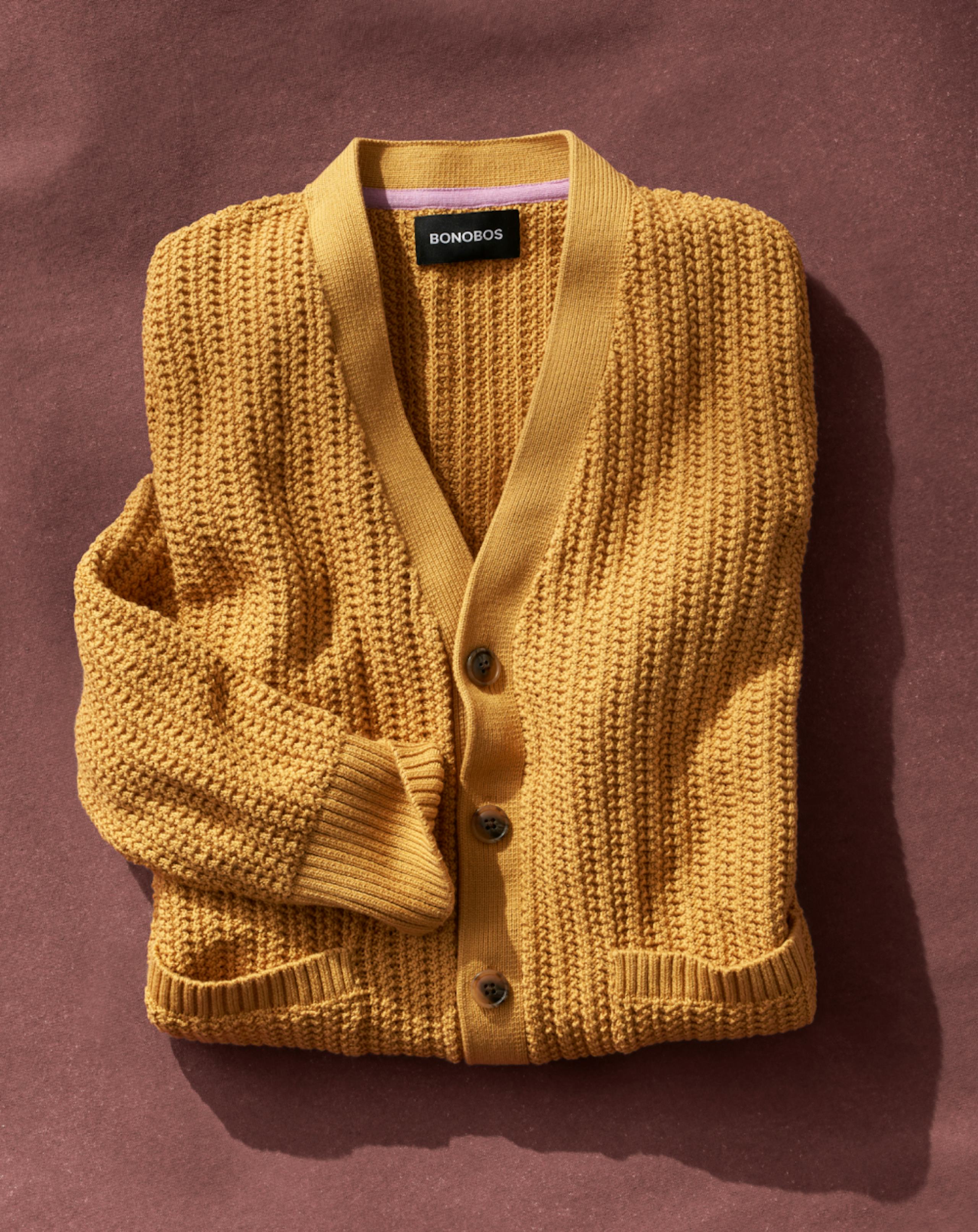 Folded yellow men's cardigan sweater