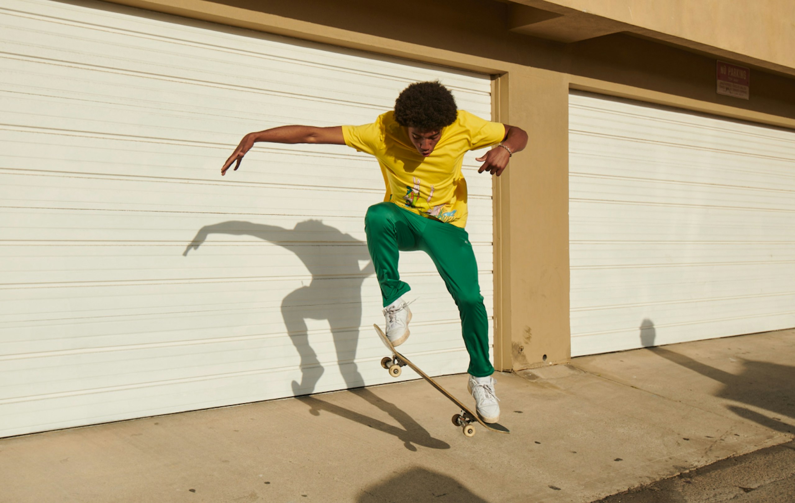 young man doing a kickflip on a skateboard. 
