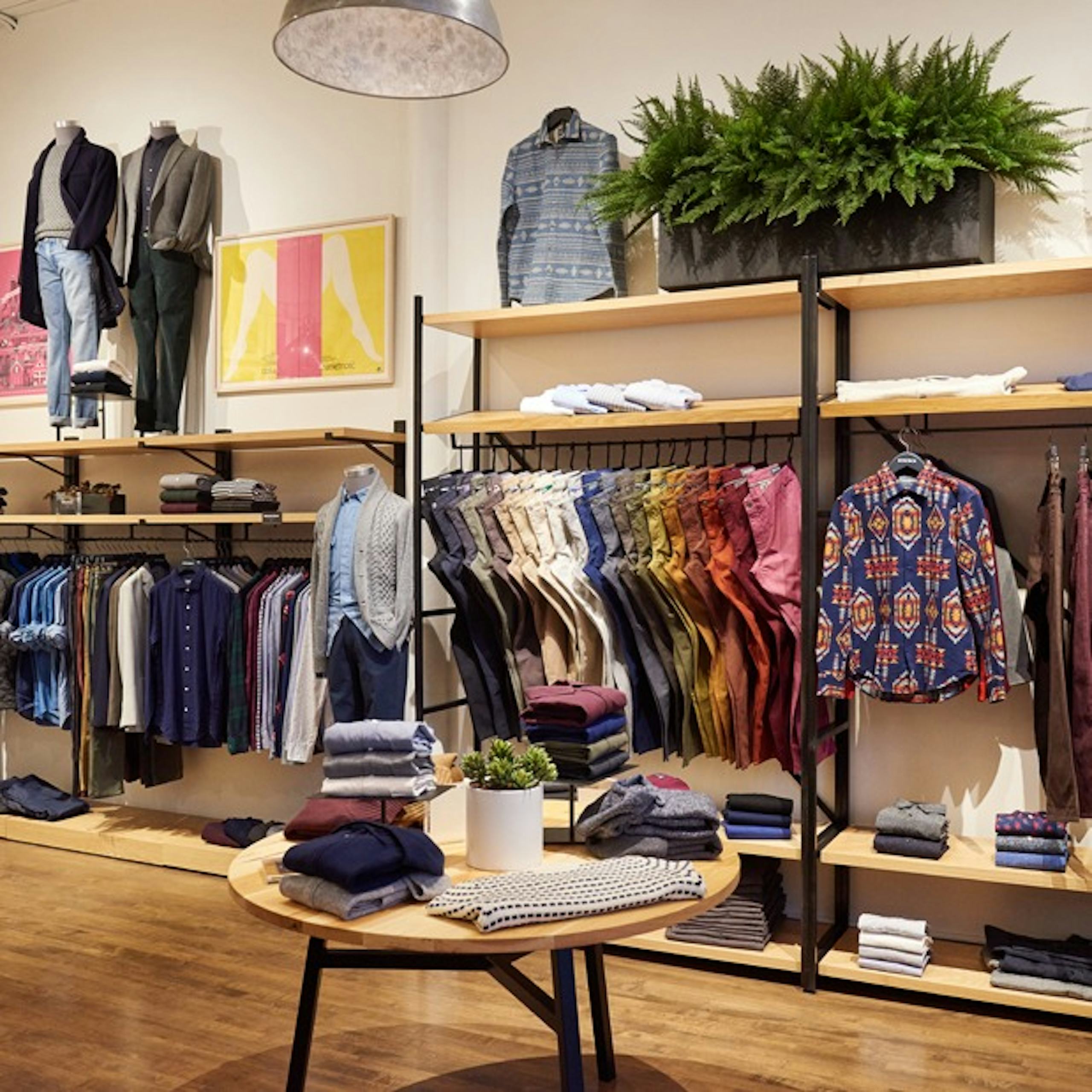 Image of Bonobos Store display in North Loop, Minneapolis. Image shows casual shirts, chinos, and outerwear. 