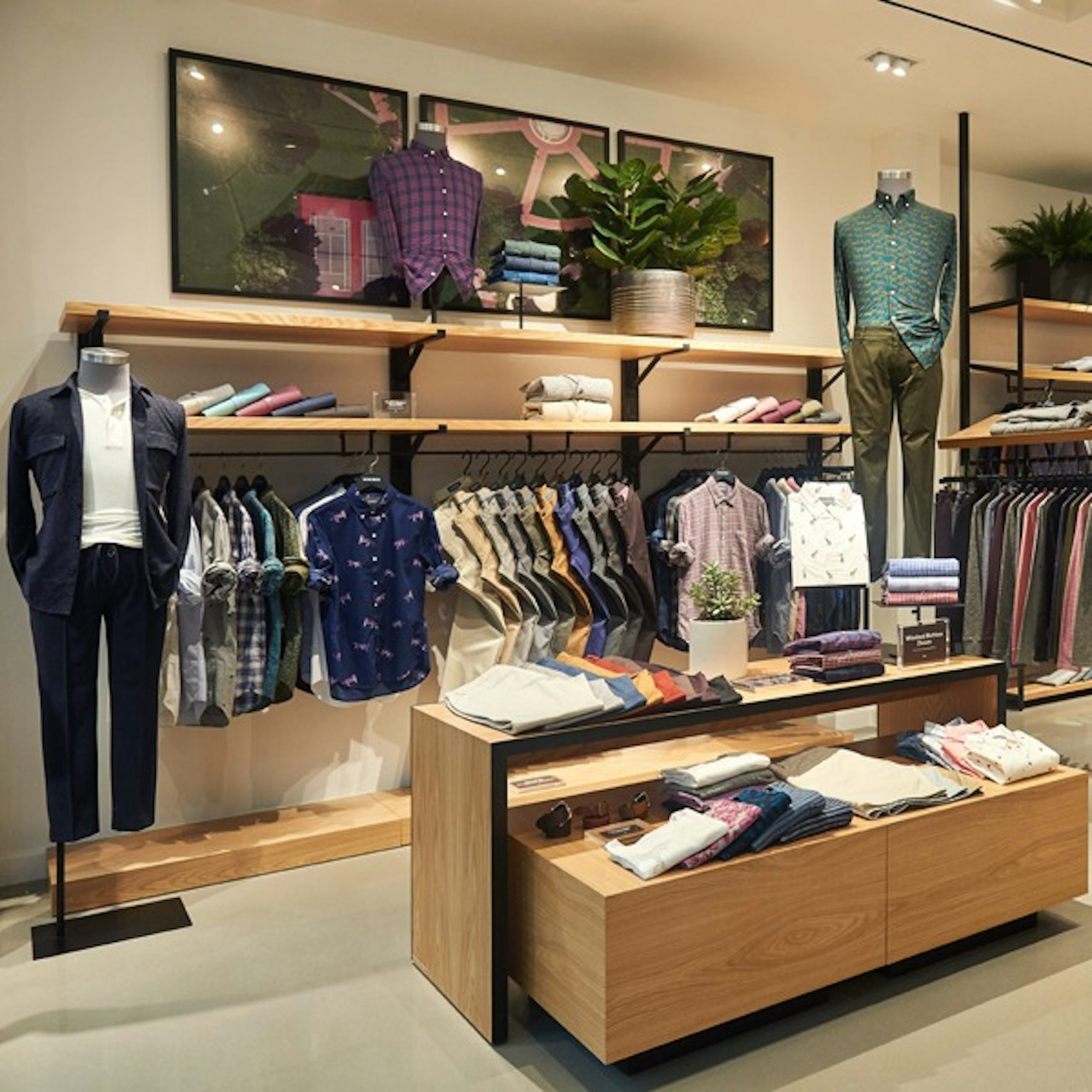 Image of Bonobos store display with outerwear, casual shirts, and chinos. 