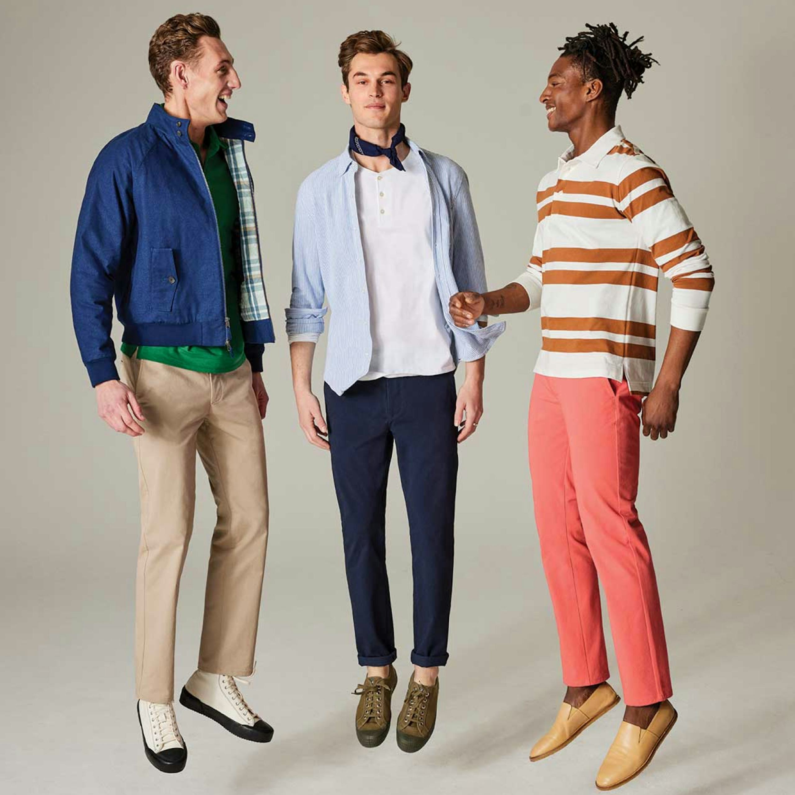 3 men jumping wearing chinos, long sleeve polos, henleys, button down shirt, and outerwear