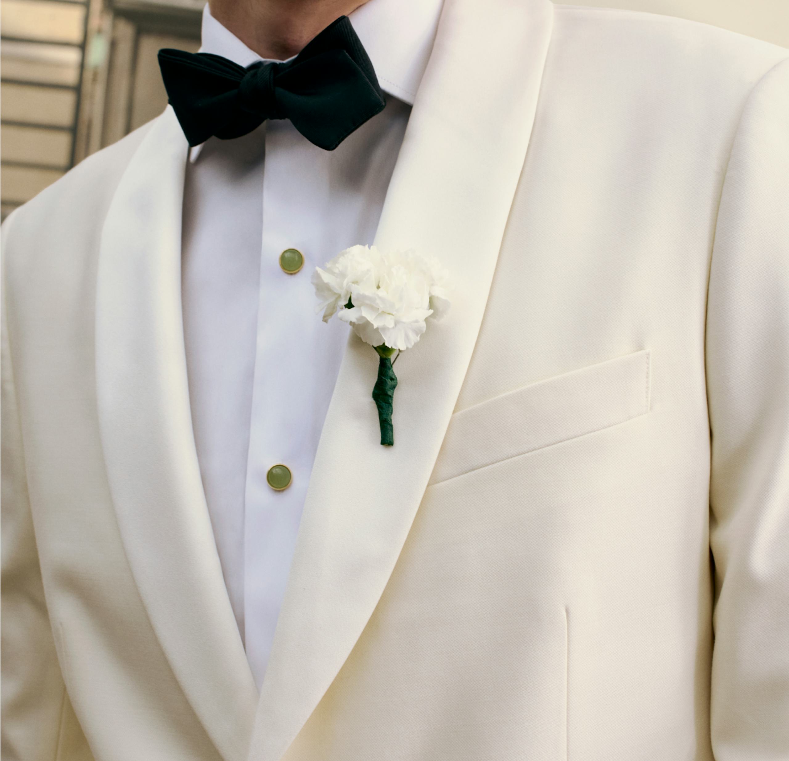 image of model wearing an empire tux and raising a champagne flute